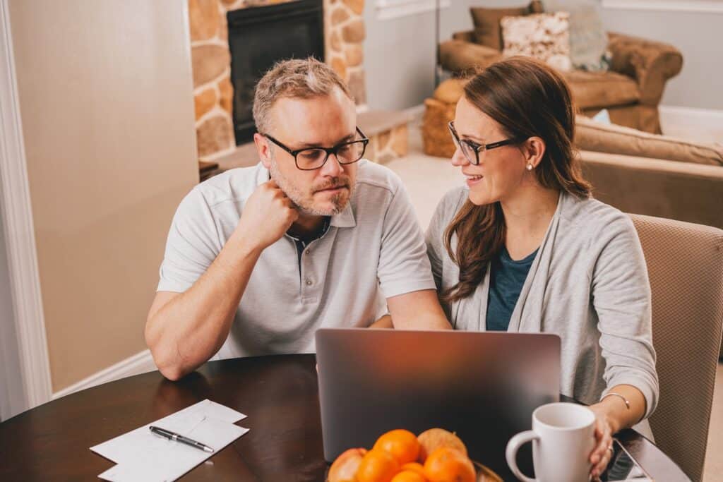 Married couple doing taxes paying bills or reviewing finances and retirement plans