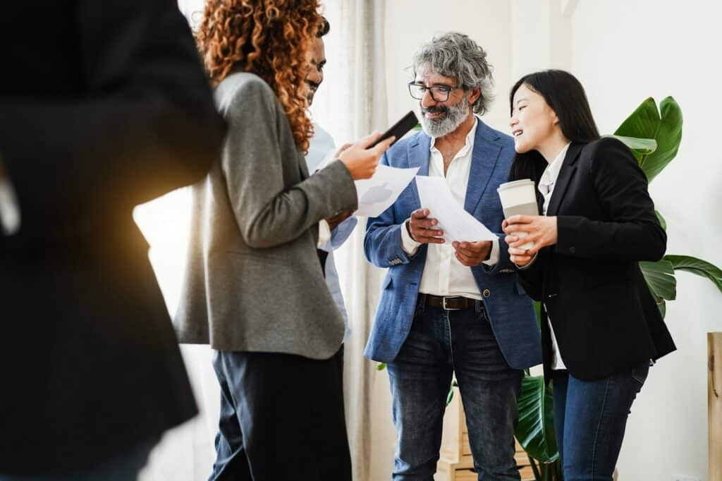 Multiracial business people working inside bank office - Focus on senior man face