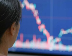 Woman watch on stock market data on computer