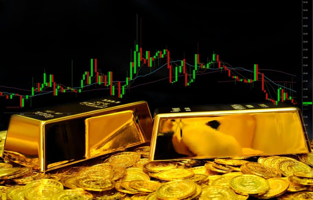Gold bullion on pile gold coins at trading chart background