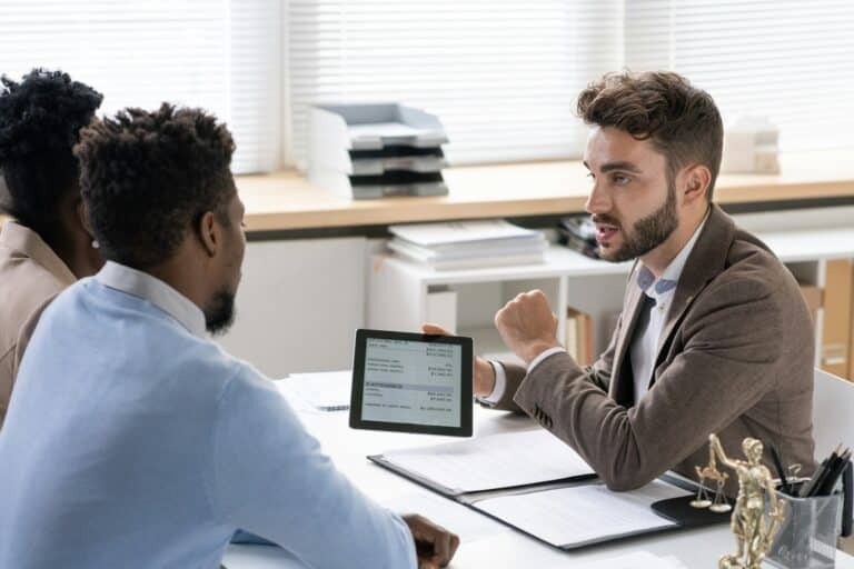 Investment Manager Talking To Young Couple