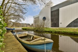 a small boat tied to a dock on a river 2023 11 27 05 14 25 utc