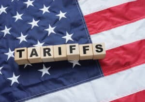 tariffs spelled in front of american flag