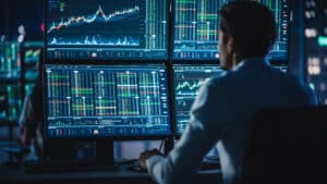 financial analysts and day traders working on a computers with m