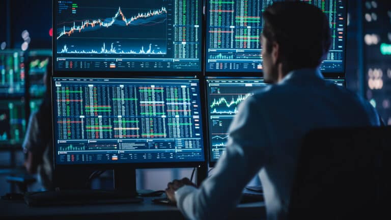 financial analysts and day traders working on a computers with m